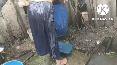 Indian house wife bathing outside