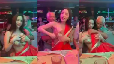 An old man squeezes a whore’s boobs at a public gathering